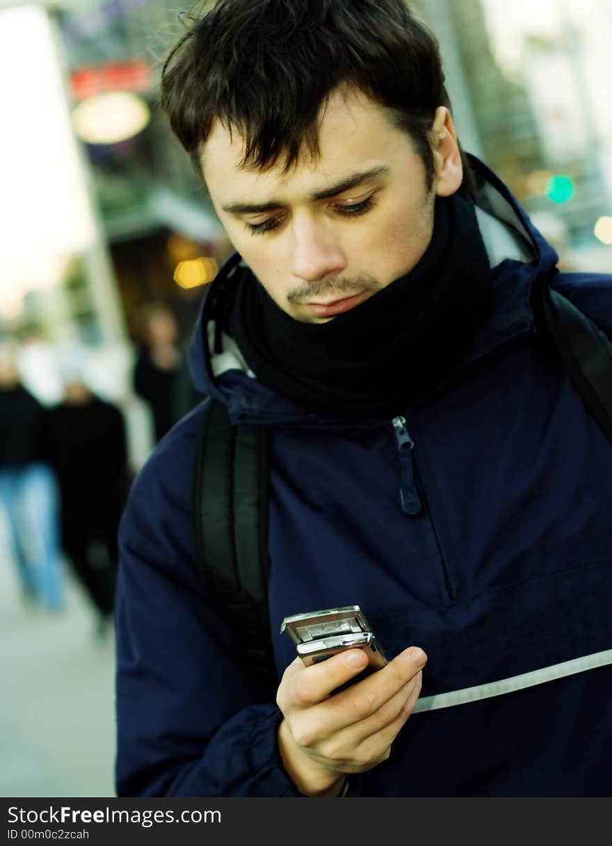 Young man looking at mobile phone. Young man looking at mobile phone