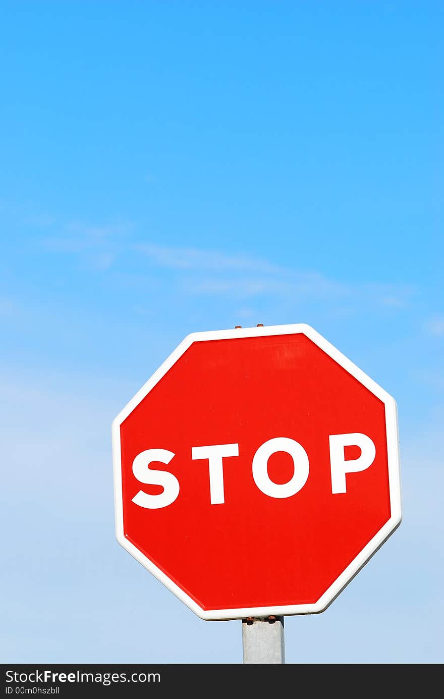 Stop sign against blue sky