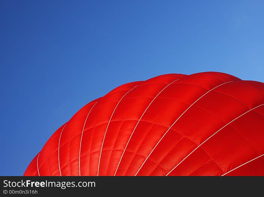 A close-up of the outside of a red air balloon. A close-up of the outside of a red air balloon