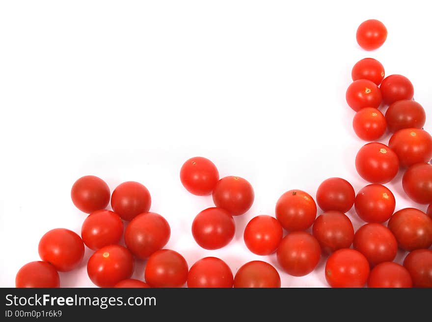 Many red tomatoes on the white background