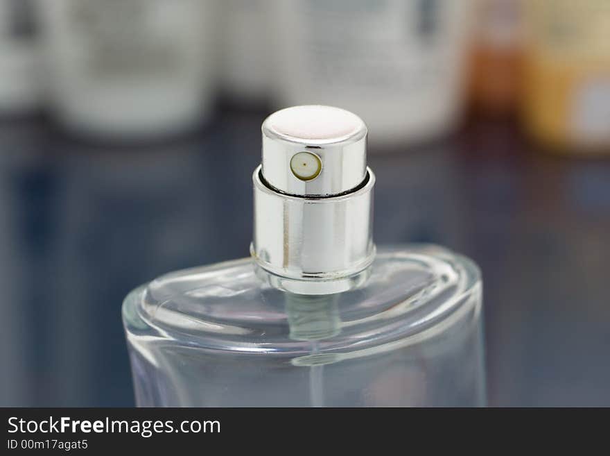 Close-up bottle of perfume on mirror table. Close-up bottle of perfume on mirror table