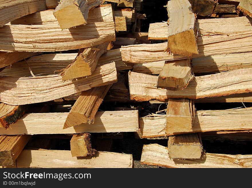 A stack of cut hardwood for fire place or stove in the winter. A stack of cut hardwood for fire place or stove in the winter