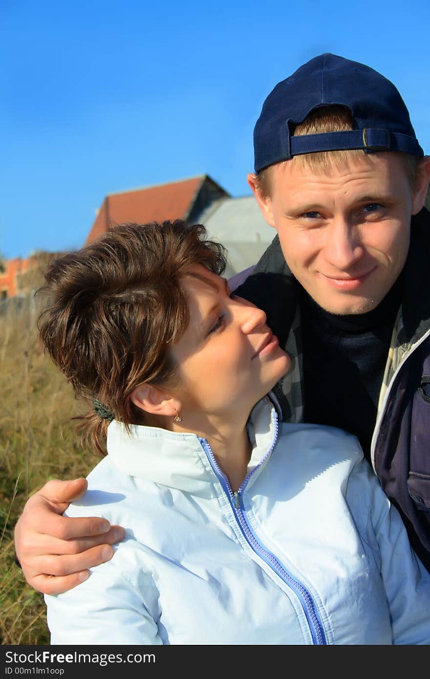 Yong smiling happy man and woman outdoors. Yong smiling happy man and woman outdoors