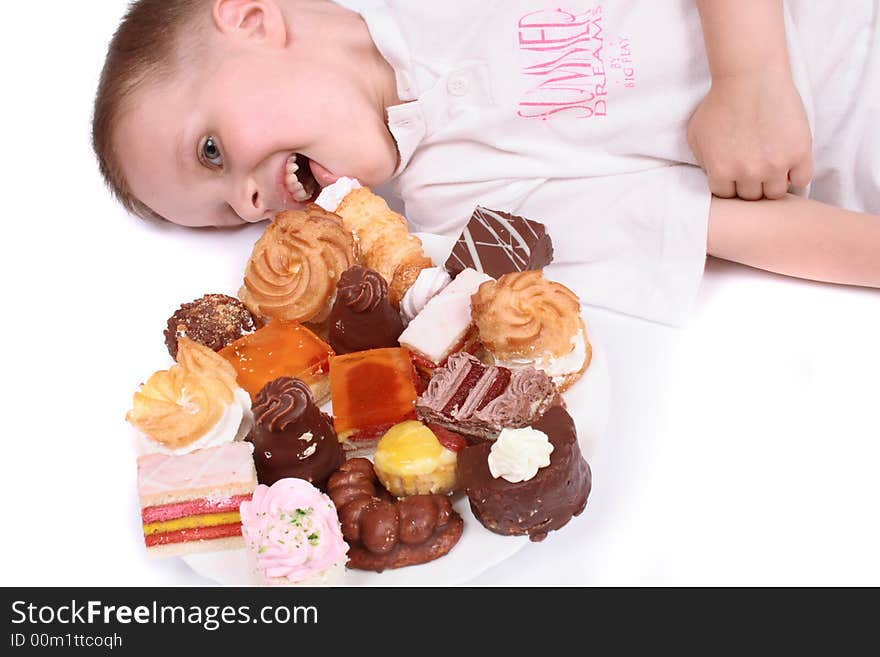 Boy is eating sweet desert on the white background. Boy is eating sweet desert on the white background