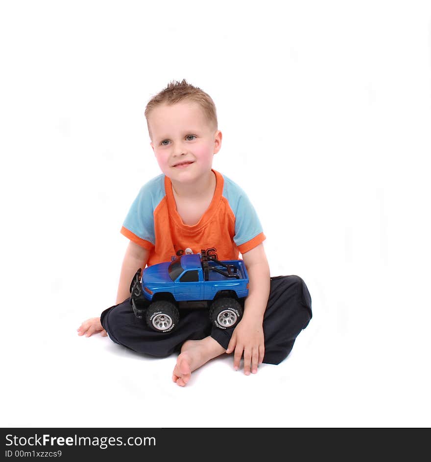 Small cute boy and his toy on the white background