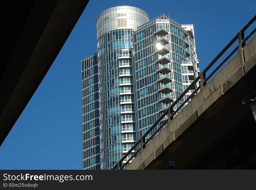 Modern residential building in Toronto, viewed in the gap between two highways. Modern residential building in Toronto, viewed in the gap between two highways