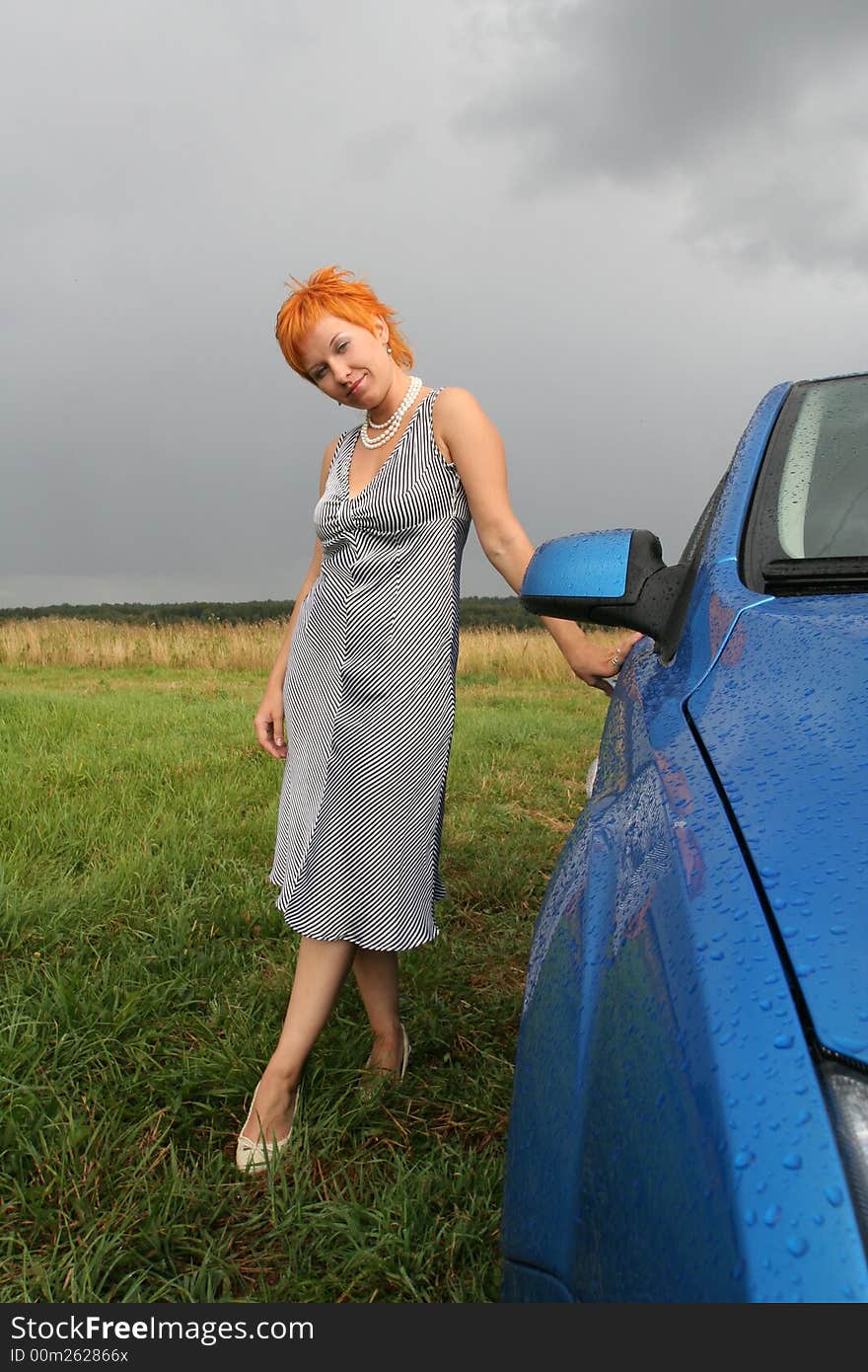 Woman In Dress With Blue Car