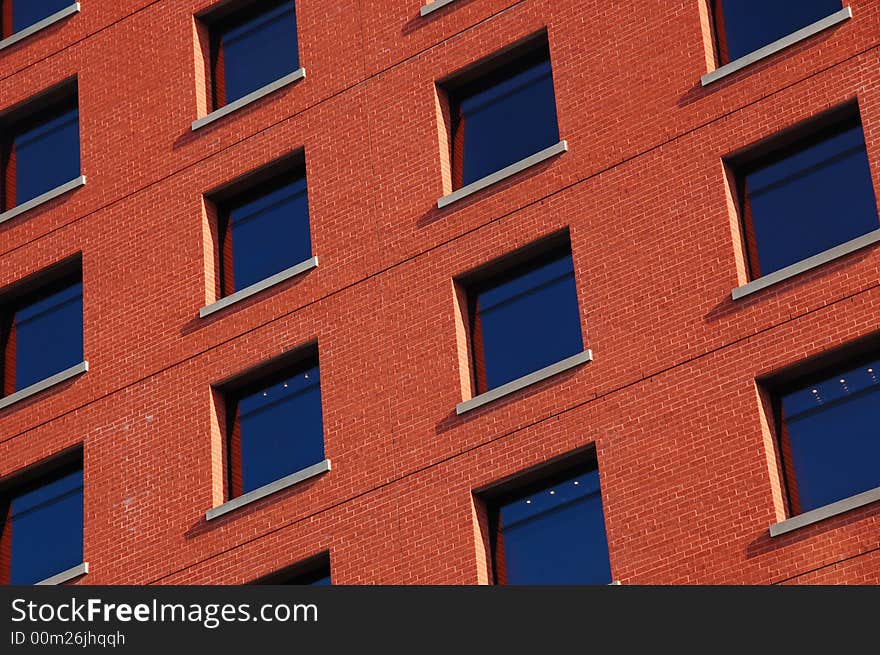 Pattern of dark blue windows on the red wall