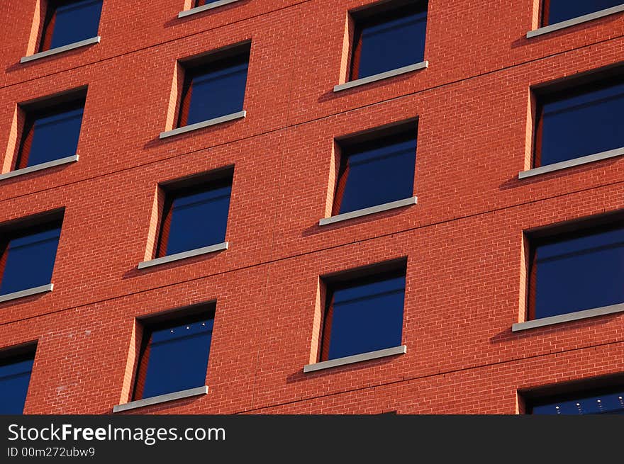 Pattern of dark blue windows on the red wall