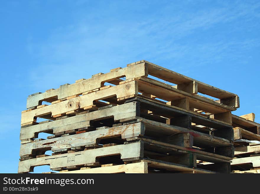 Stacked Pallets against a blue sky