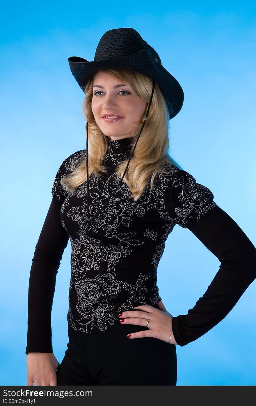 The beauty blonde in the studio, isolated on a blue background. The beauty blonde in the studio, isolated on a blue background.