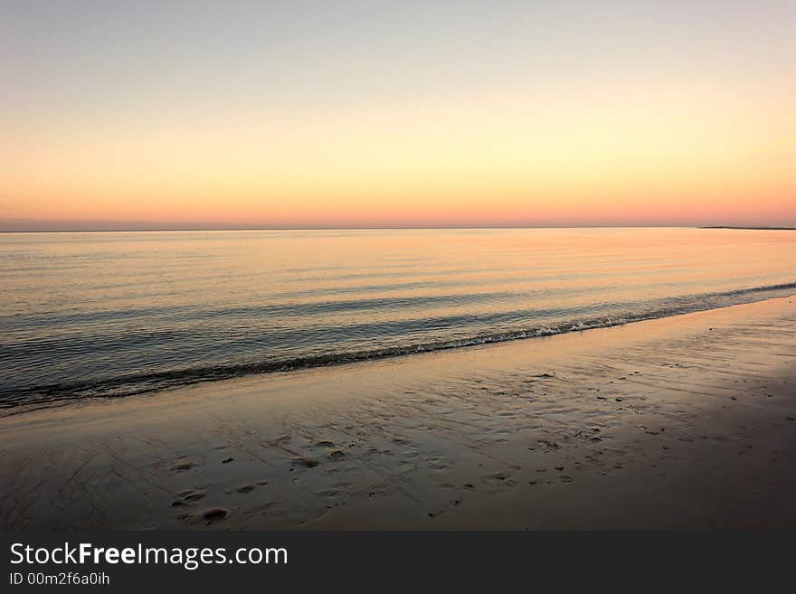 Sunset on Crane's beach in Ipswich Massachusetts with land way off in the distance. Sunset on Crane's beach in Ipswich Massachusetts with land way off in the distance