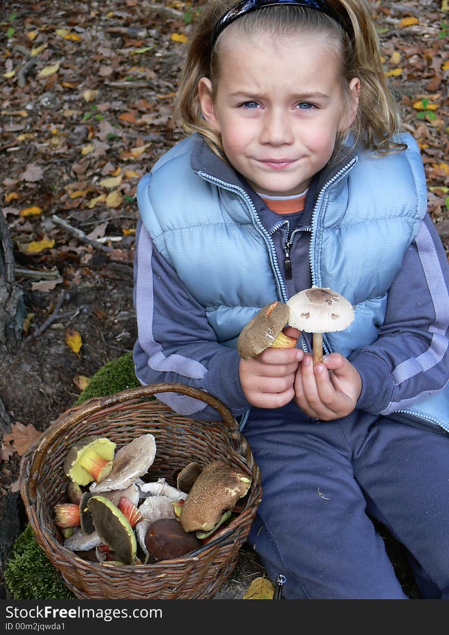 Small boy showing mushrooms