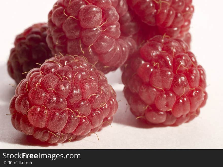 Five raspberries isolated on awhite background