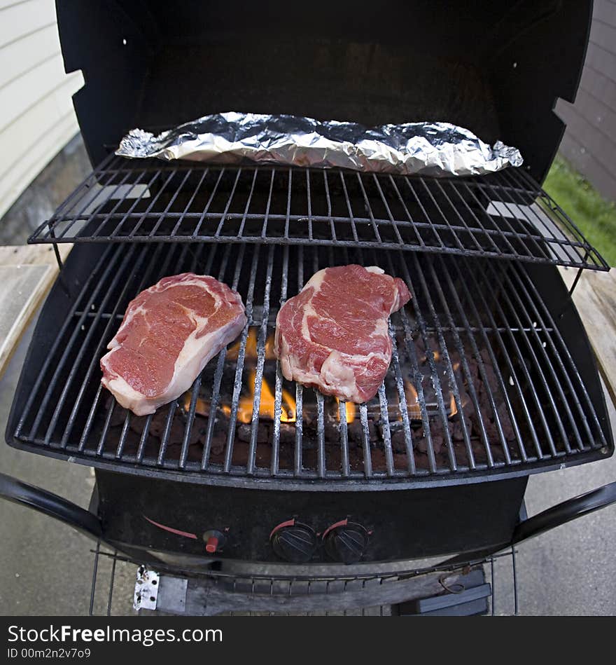 A photo of 2 steaks on a grill