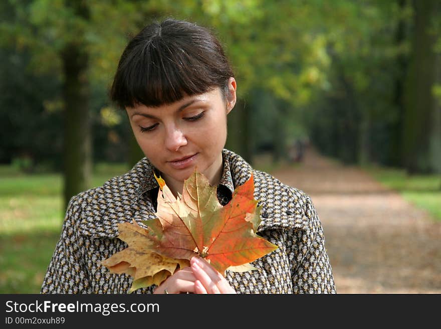 Beautiful woman walking in the autumn park. Beautiful woman walking in the autumn park