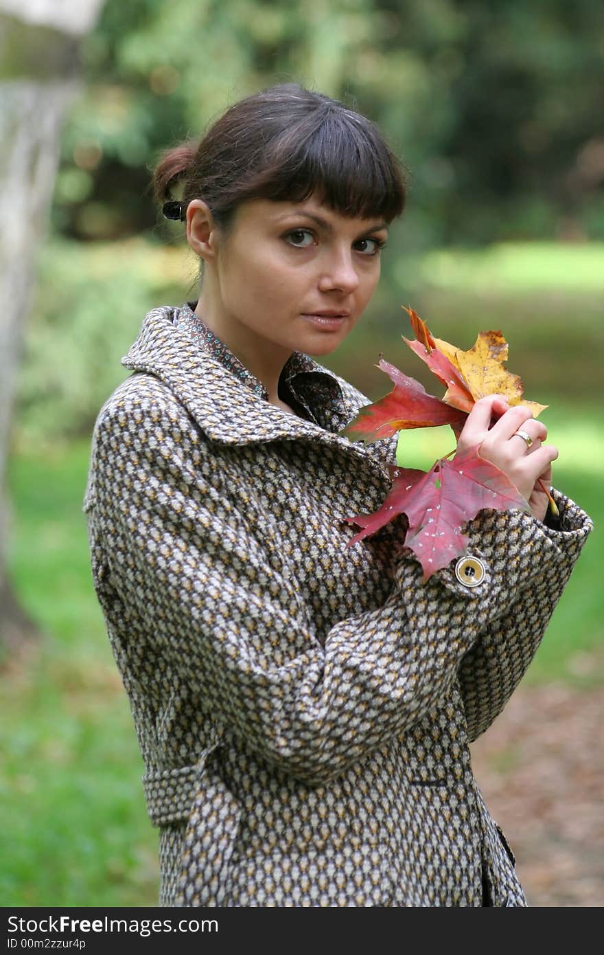 Beautiful woman walking in the autumn park. Beautiful woman walking in the autumn park