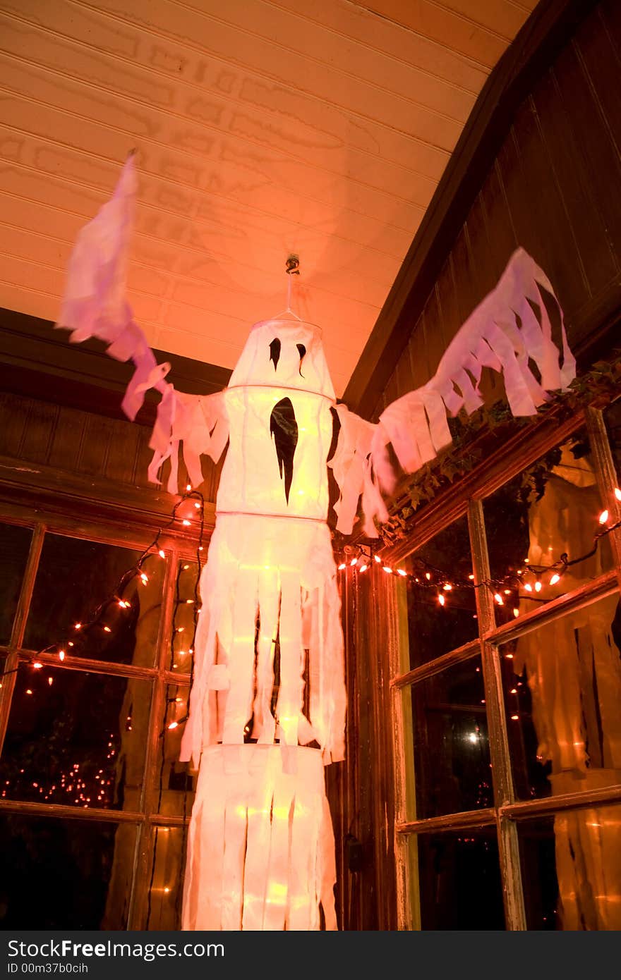 Fluttering white ghost halloween decoration in old room