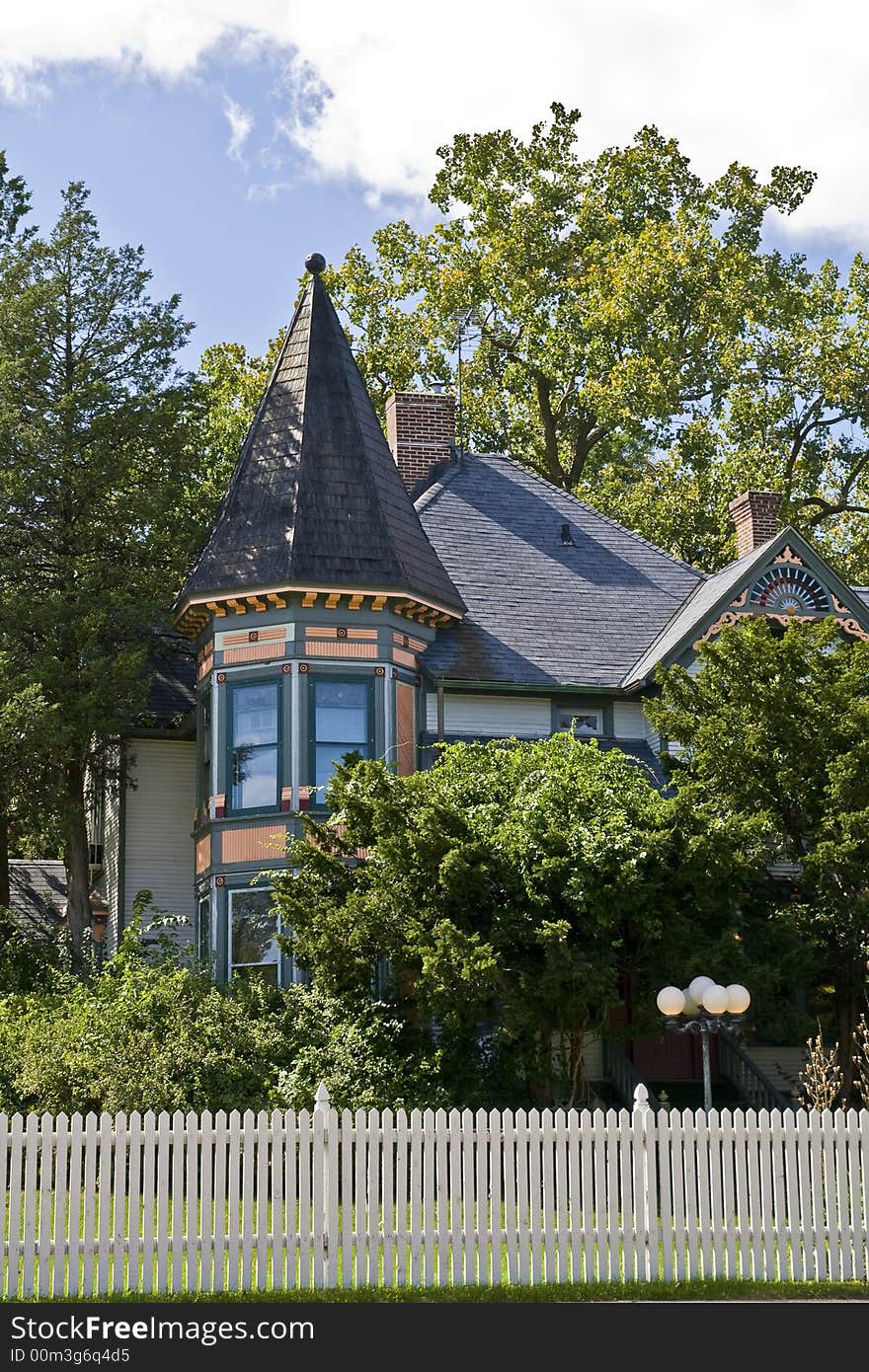 Colorful victorian house hiding in the trees. Colorful victorian house hiding in the trees