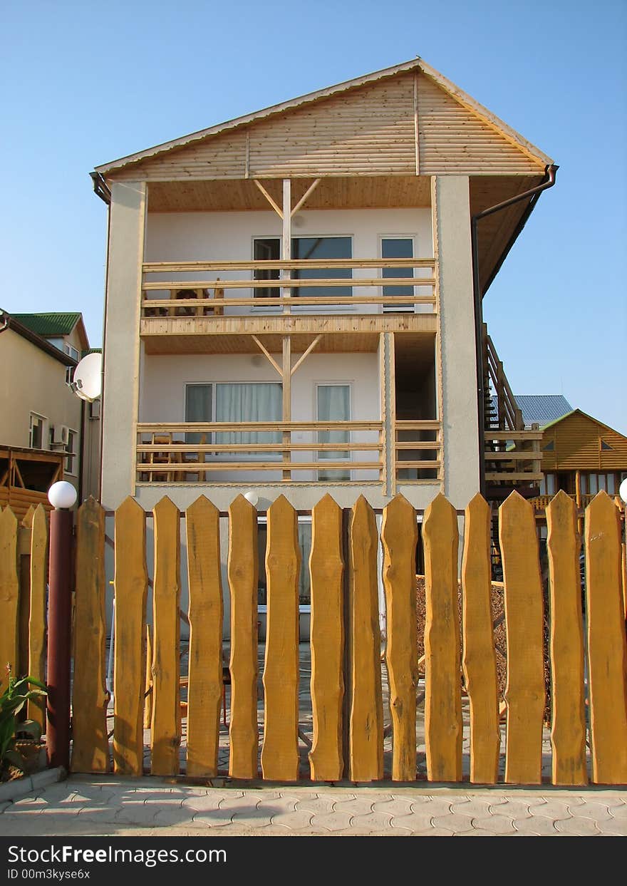 House, encircled by wooden fence