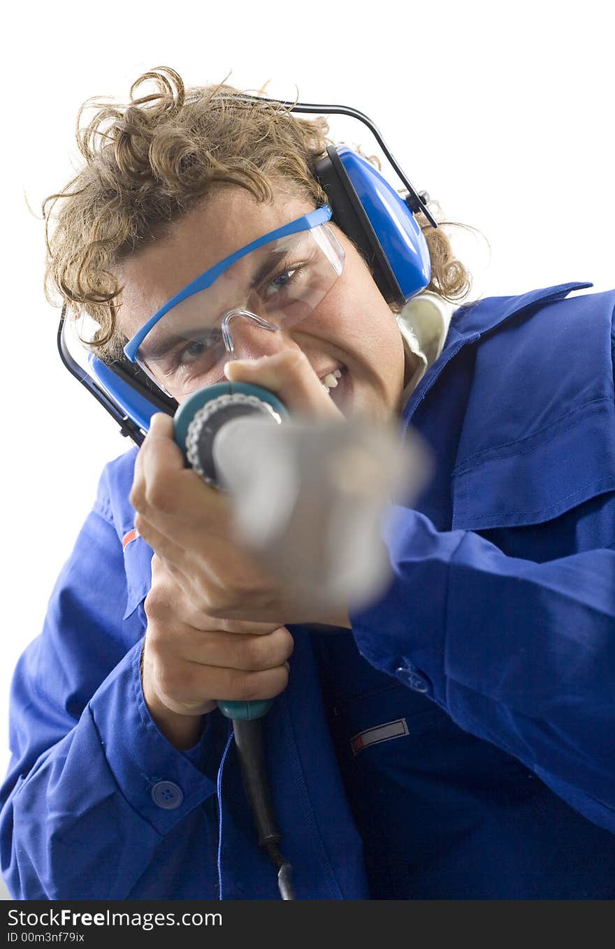 Young man with drill. He's looking at camera. White background. Young man with drill. He's looking at camera. White background