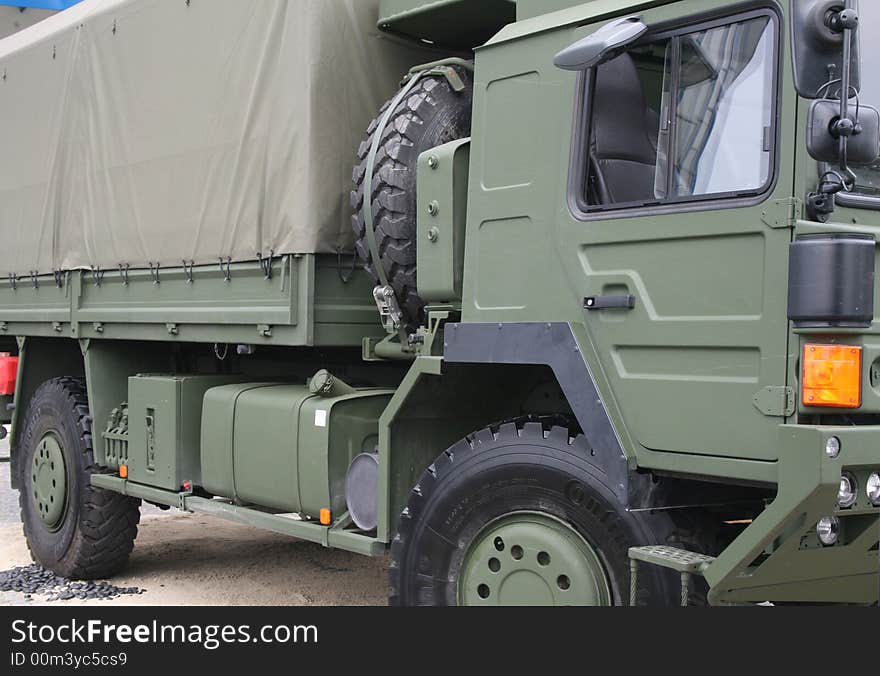 Military truck, side view, in a trade fair