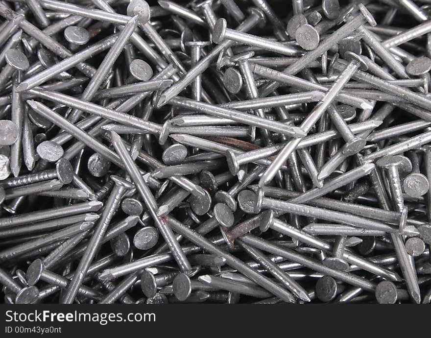 Technological metal background from the steel nails. Technological metal background from the steel nails