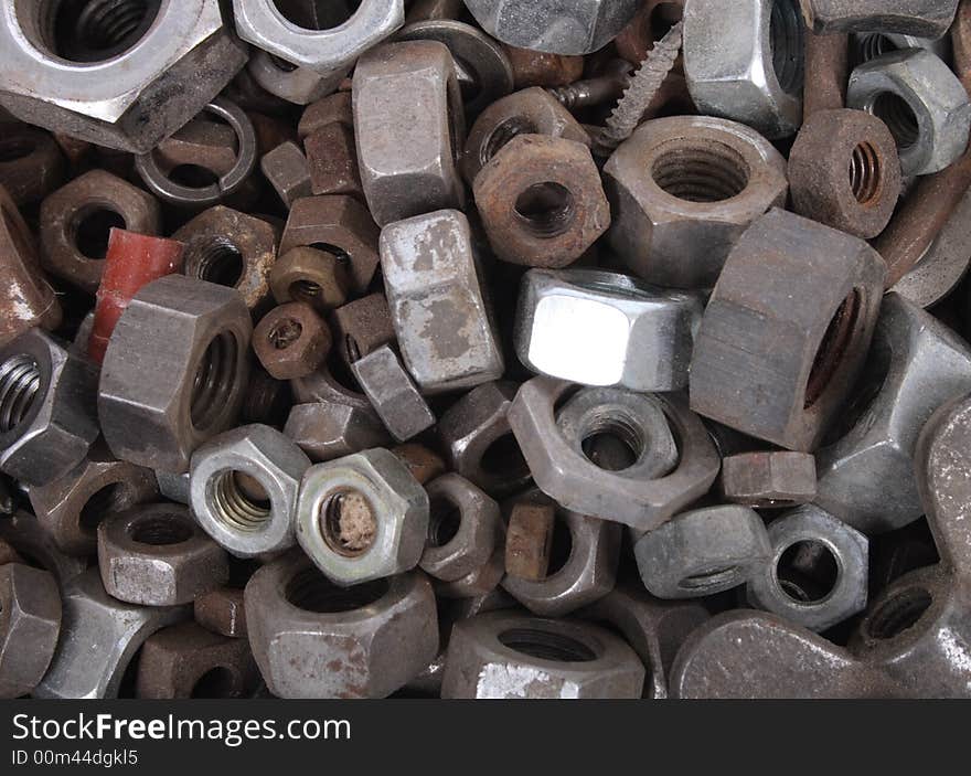 Technological metal background from the steel nuts. Technological metal background from the steel nuts