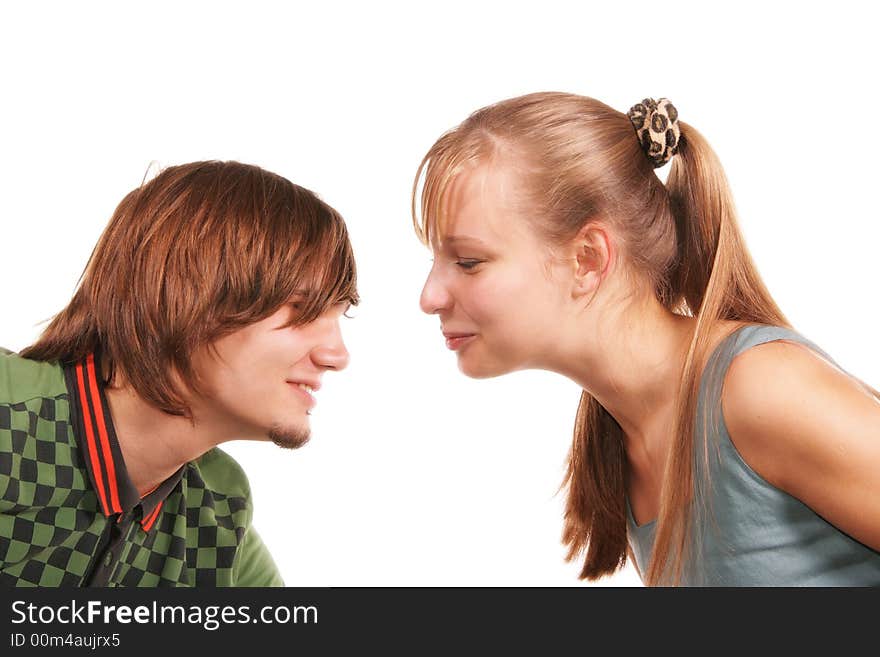 Attractive young woman and man face to face isolated over white background