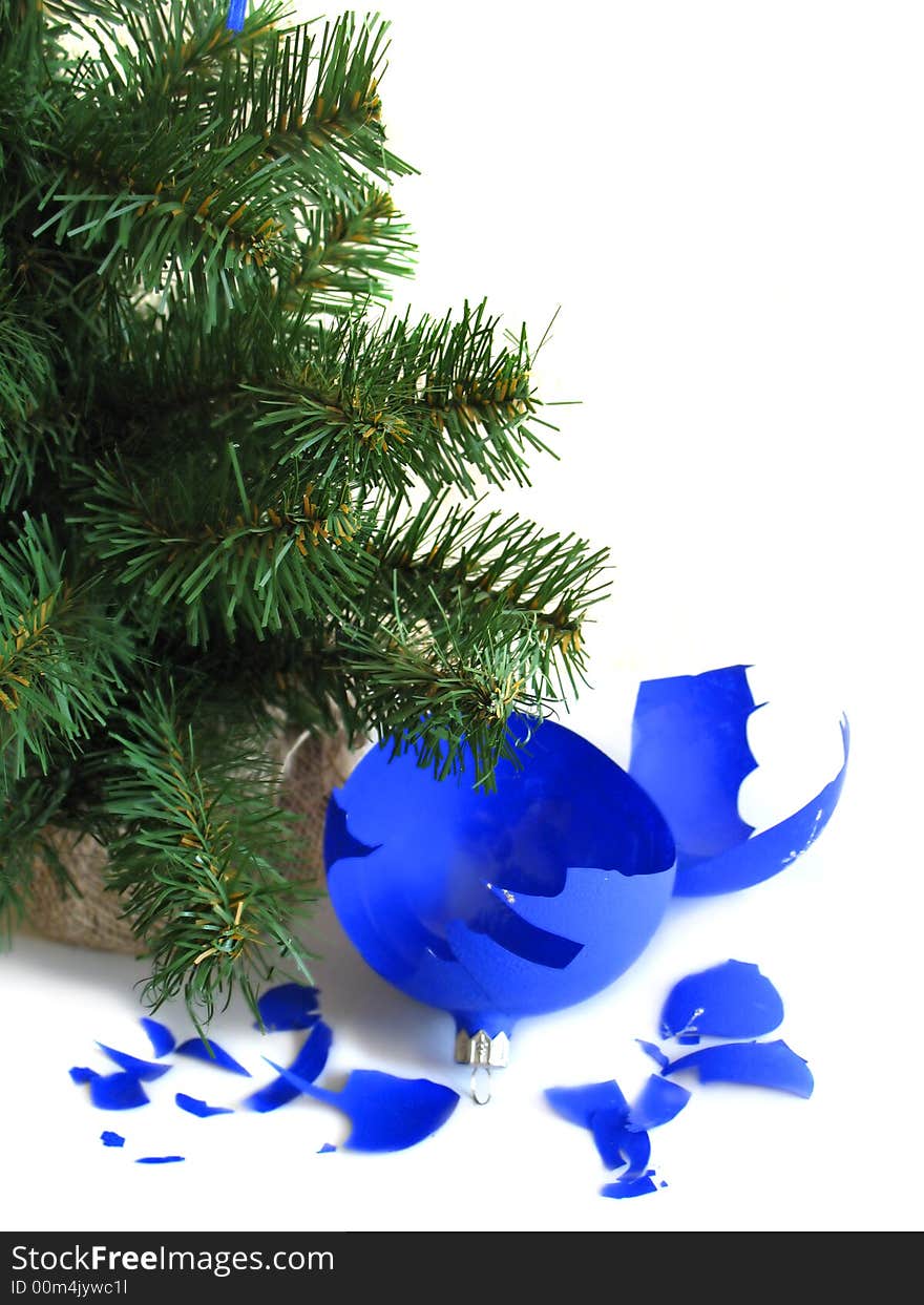 Pieces of broken blue ball with Christmas tree