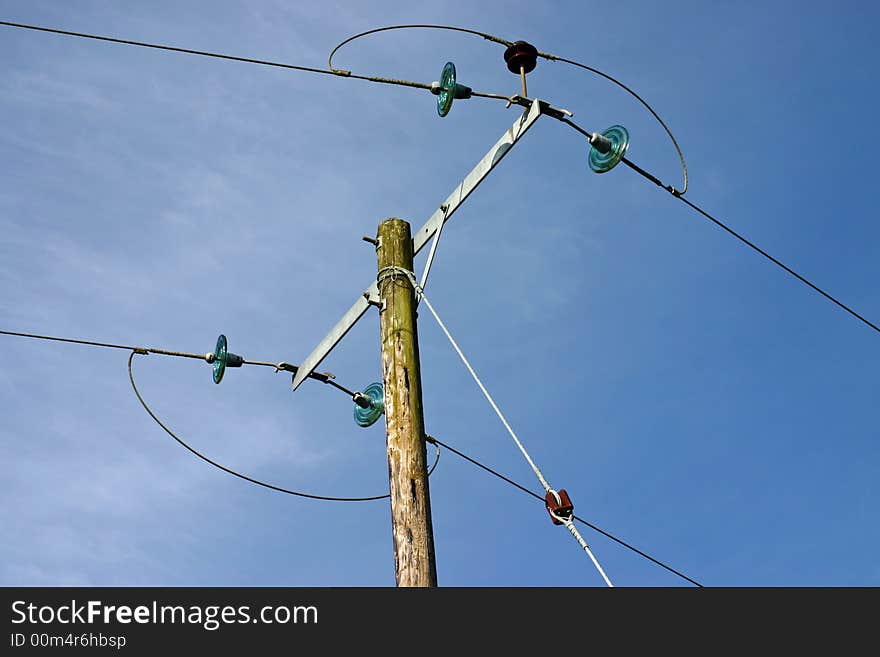 Rural electricity pylon against a blue sky. Rural electricity pylon against a blue sky