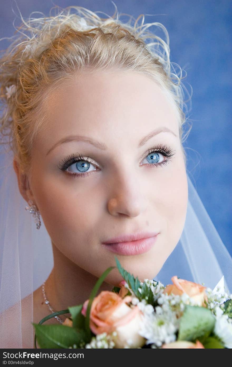 The bride holds a bouquet and pensively looks. The bride holds a bouquet and pensively looks