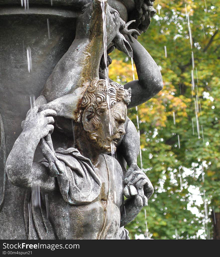 Sculputre of man carrying a deer on his back. Sculputre of man carrying a deer on his back