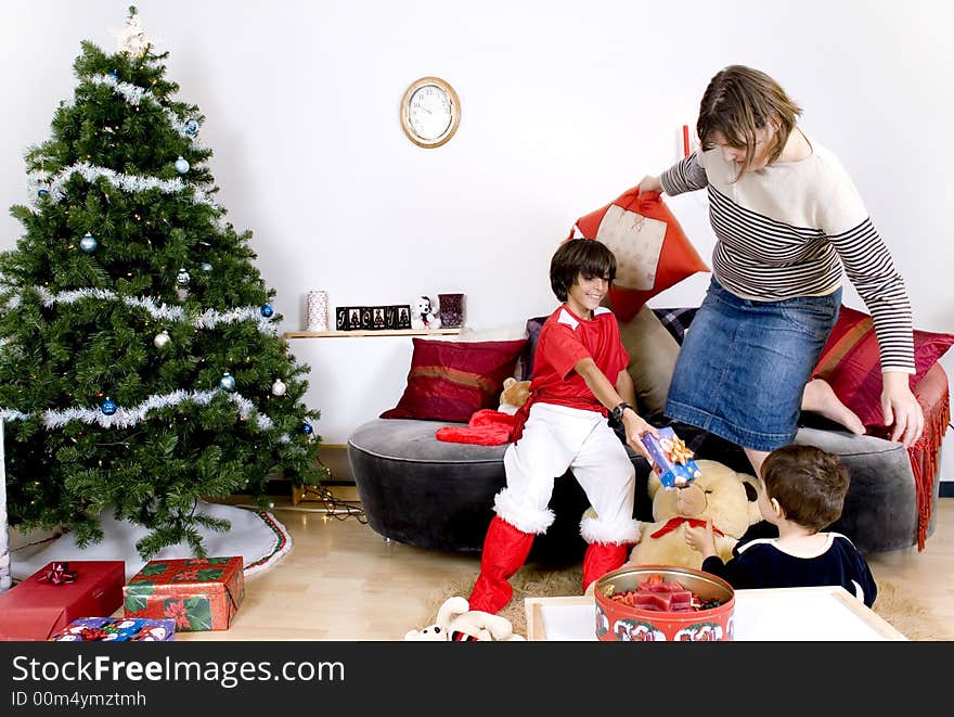 Happy family having fun and opening gift at christmas time. Happy family having fun and opening gift at christmas time