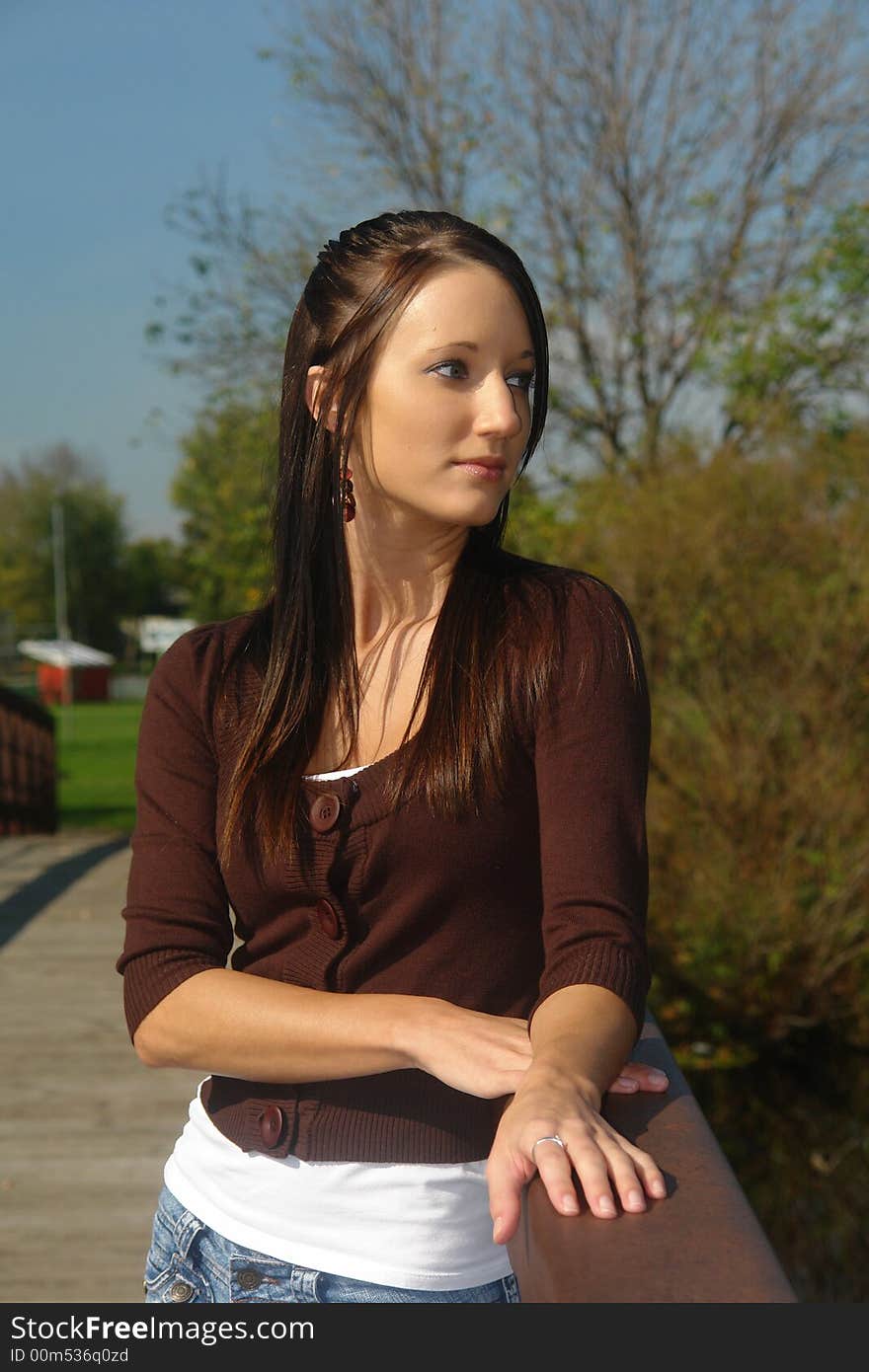 A picture of a beautiful young woman looking away from camera. A picture of a beautiful young woman looking away from camera