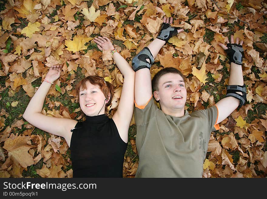 Young  Couple Lies In Leaves