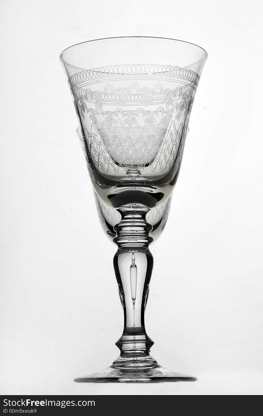 Two glasses one behind another on a white background