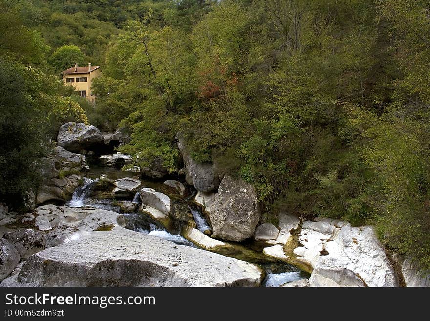 Little house staying in mountains near the waterfall. Little house staying in mountains near the waterfall