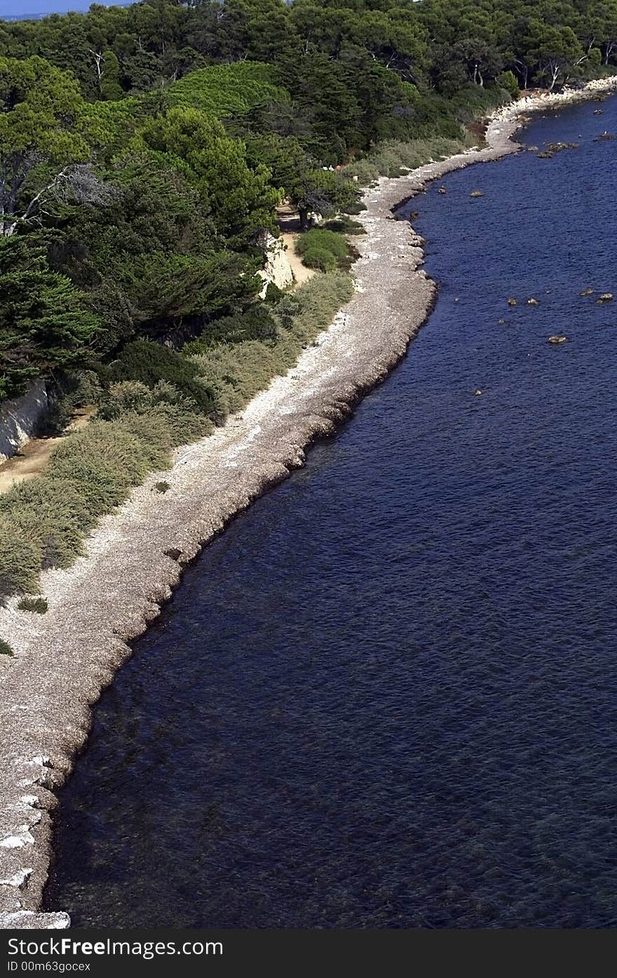 Panorama of coastline of an island with the forest growing on it. Panorama of coastline of an island with the forest growing on it