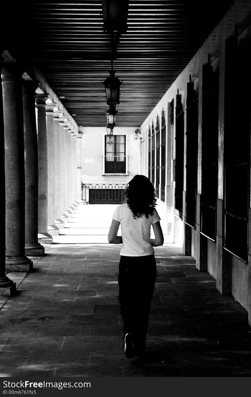 Girl inside an alley, Toledo city, Spain. Grained for more drama.