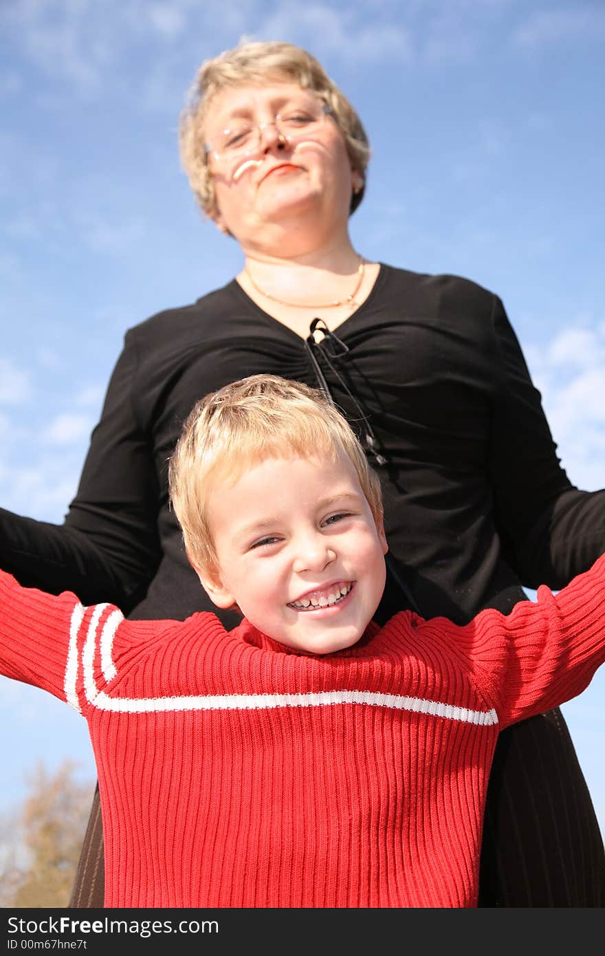 Grandmother with the grandson against sky. Grandmother with the grandson against sky