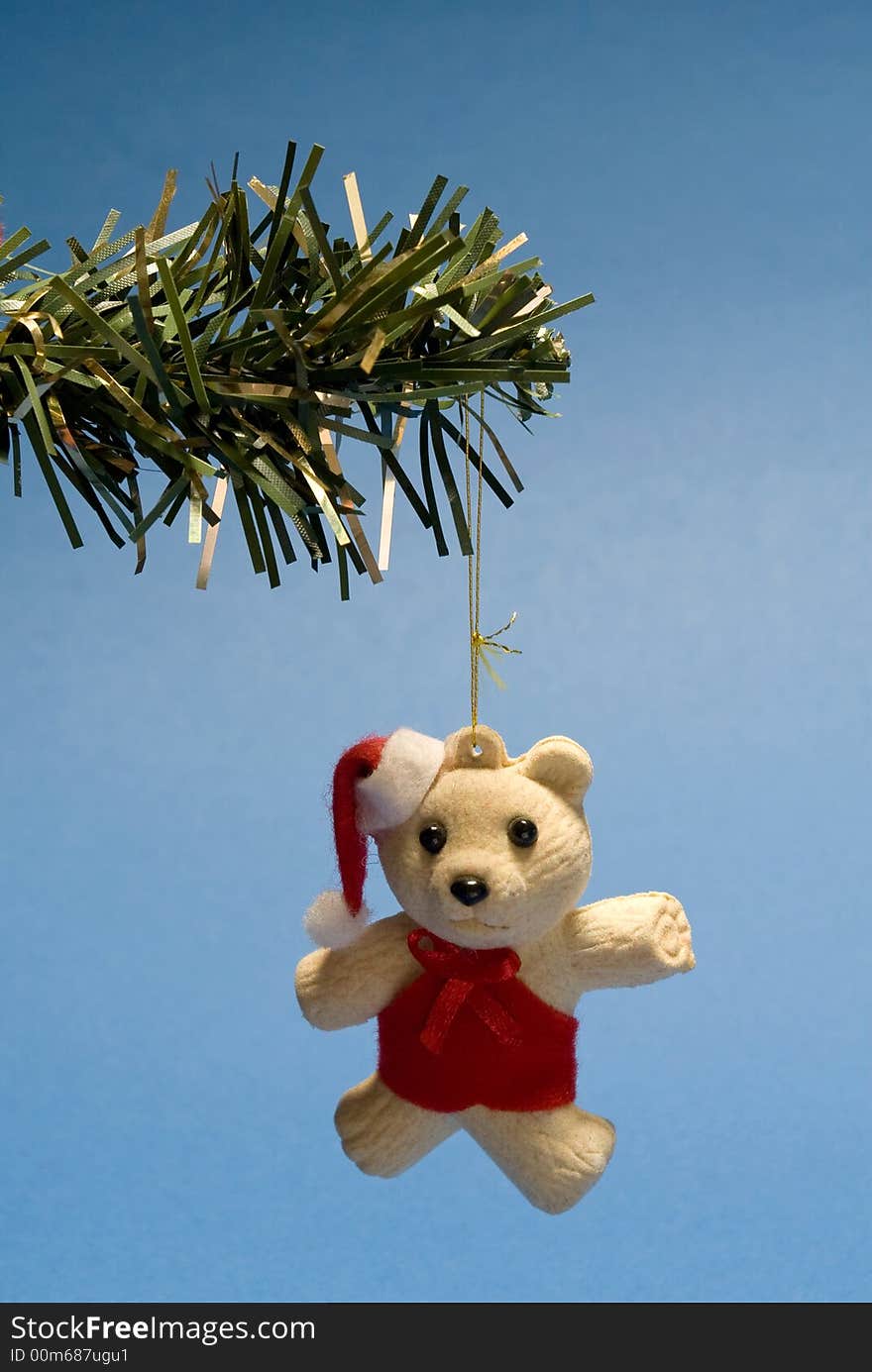 Christmas teddy bear hanging in christmas tree