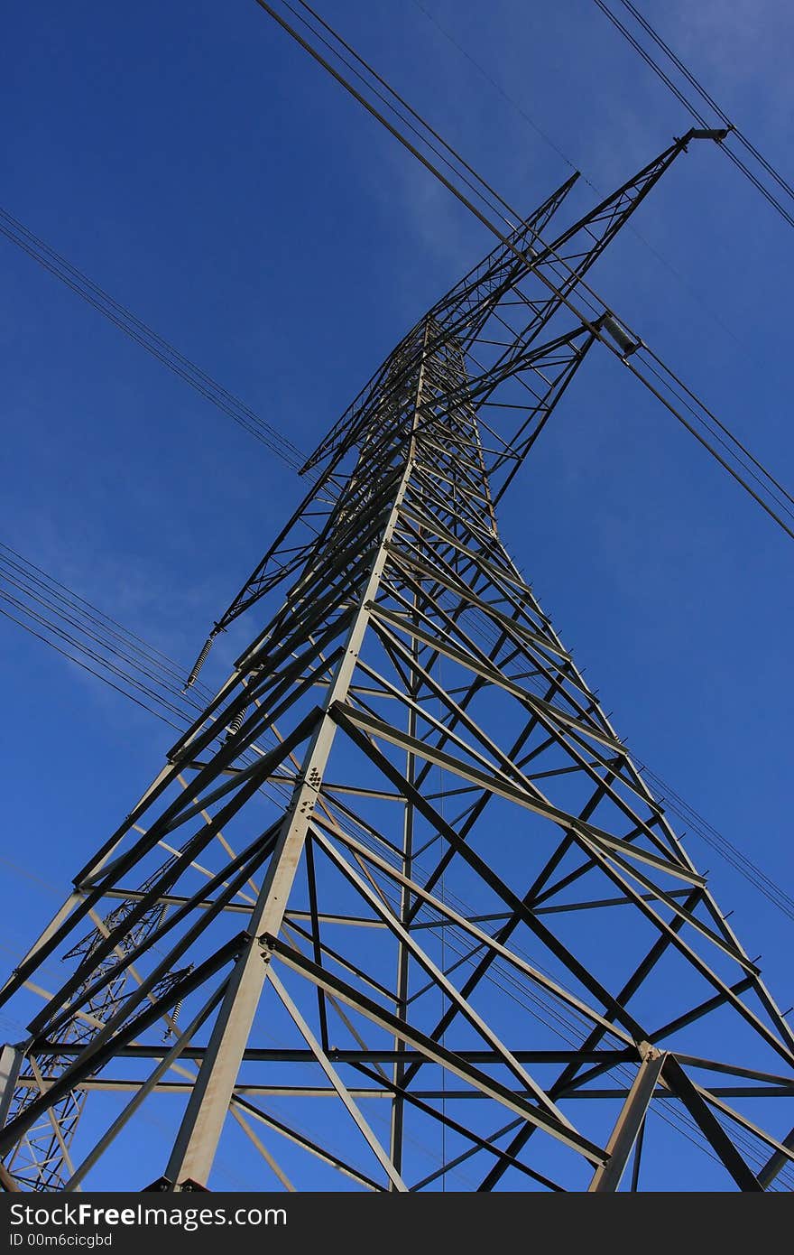 Looking skyward along a high tension tower  while power lines cross the vertical axis. Looking skyward along a high tension tower  while power lines cross the vertical axis