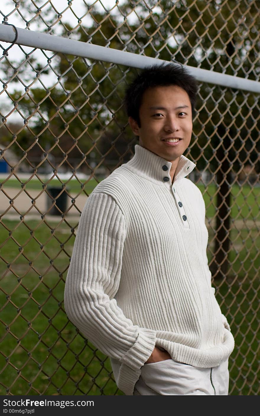 A boy standing in tennis court wearing sports clothing. A boy standing in tennis court wearing sports clothing