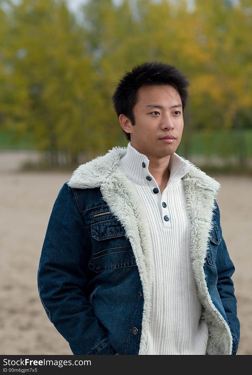 A boy standing on the woodbine beach wearing sports clothing. A boy standing on the woodbine beach wearing sports clothing