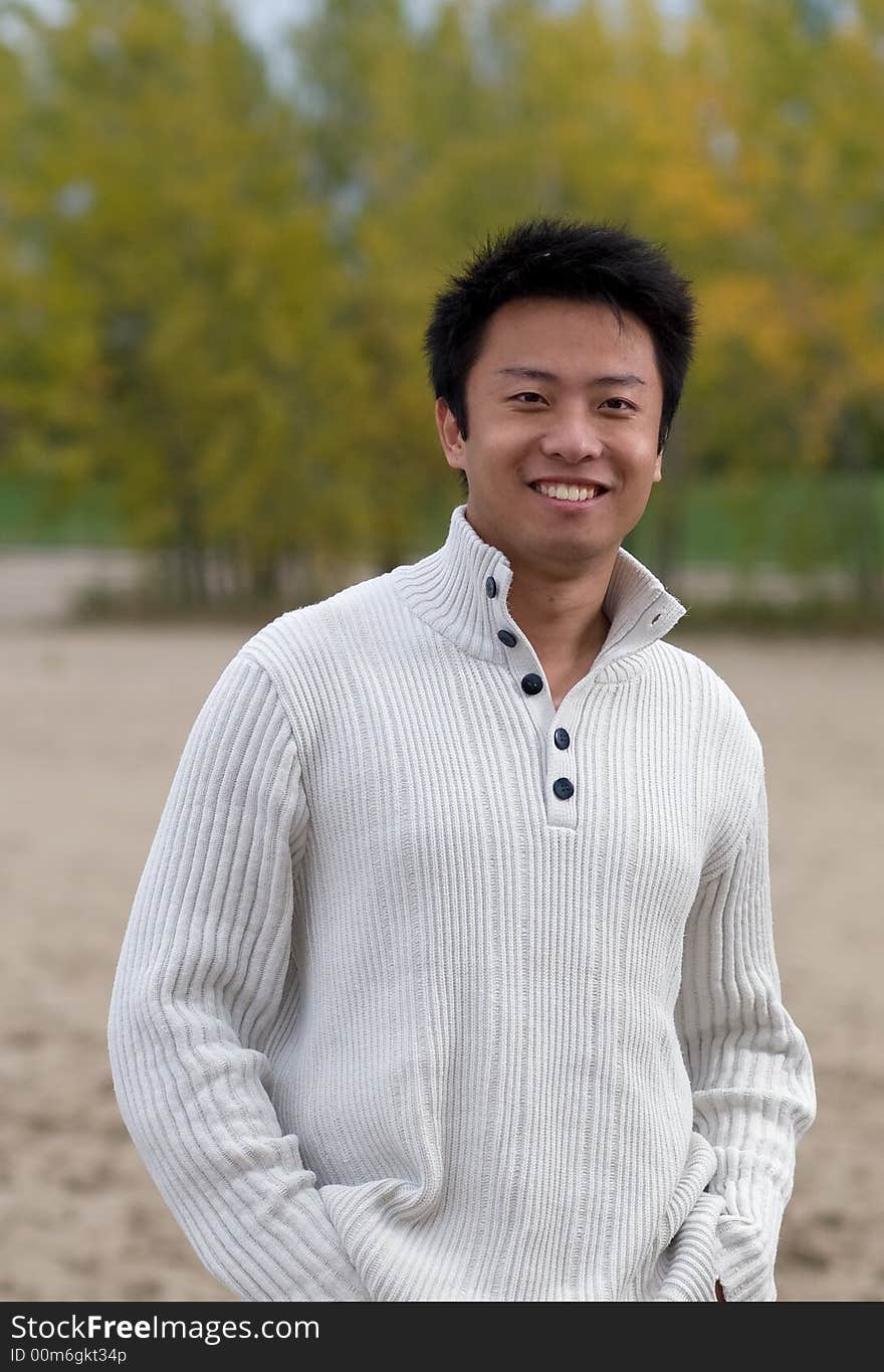 A boy standing on the woodbine beach wearing sports clothing. A boy standing on the woodbine beach wearing sports clothing