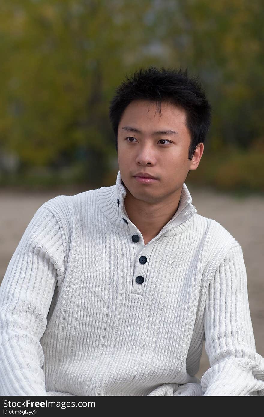 A boy standing on the woodbine beach wearing sports clothing. A boy standing on the woodbine beach wearing sports clothing