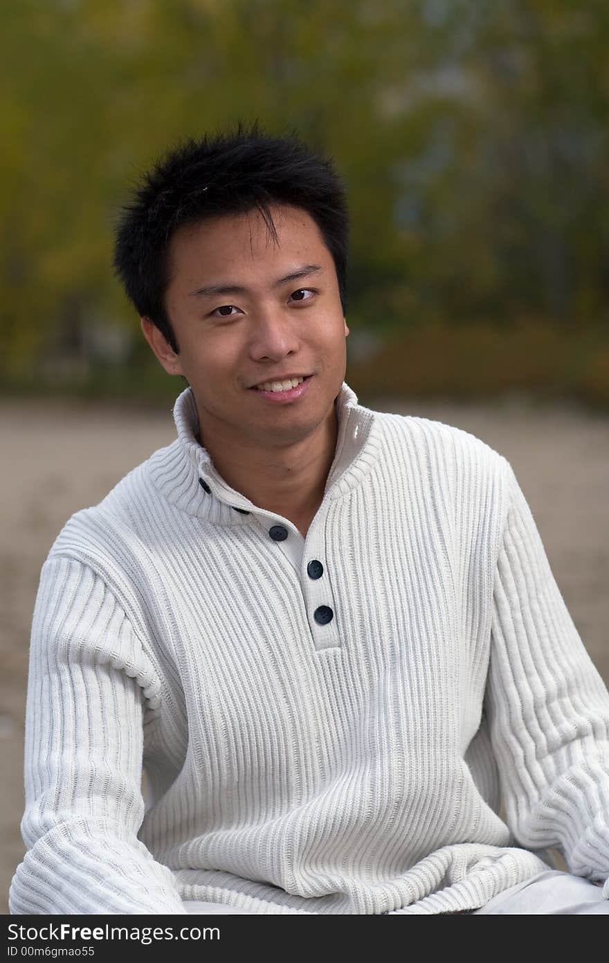 A boy standing on the woodbine beach wearing sports clothing. A boy standing on the woodbine beach wearing sports clothing