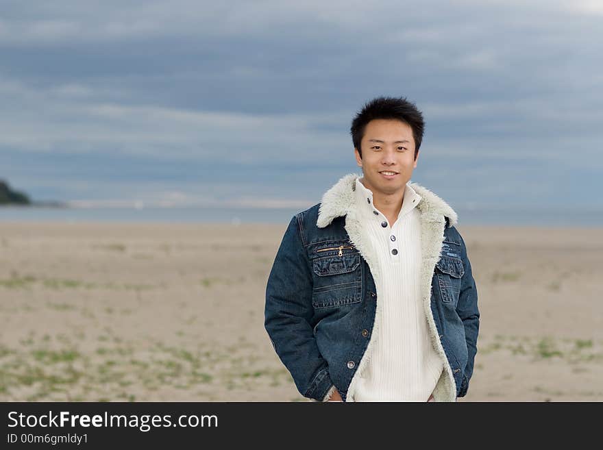 A boy standing on the woodbine beach wearing sports clothing. A boy standing on the woodbine beach wearing sports clothing