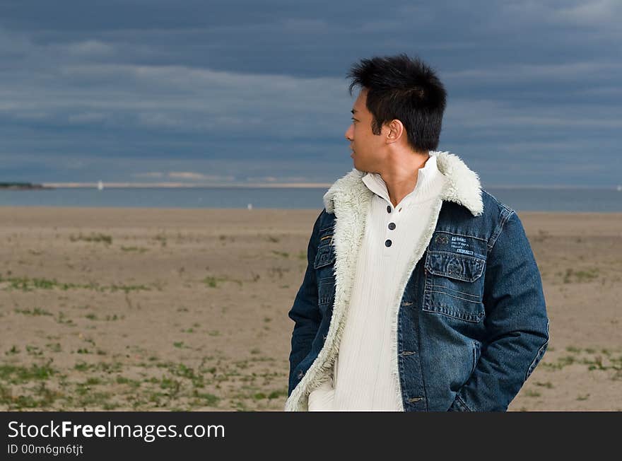 A boy standing on the woodbine beach wearing sports clothing. A boy standing on the woodbine beach wearing sports clothing